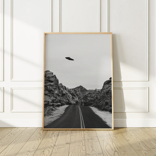 UFO flies over a road in Nevada Poster